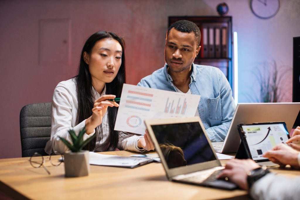 Diverse colleagues working late at modern office